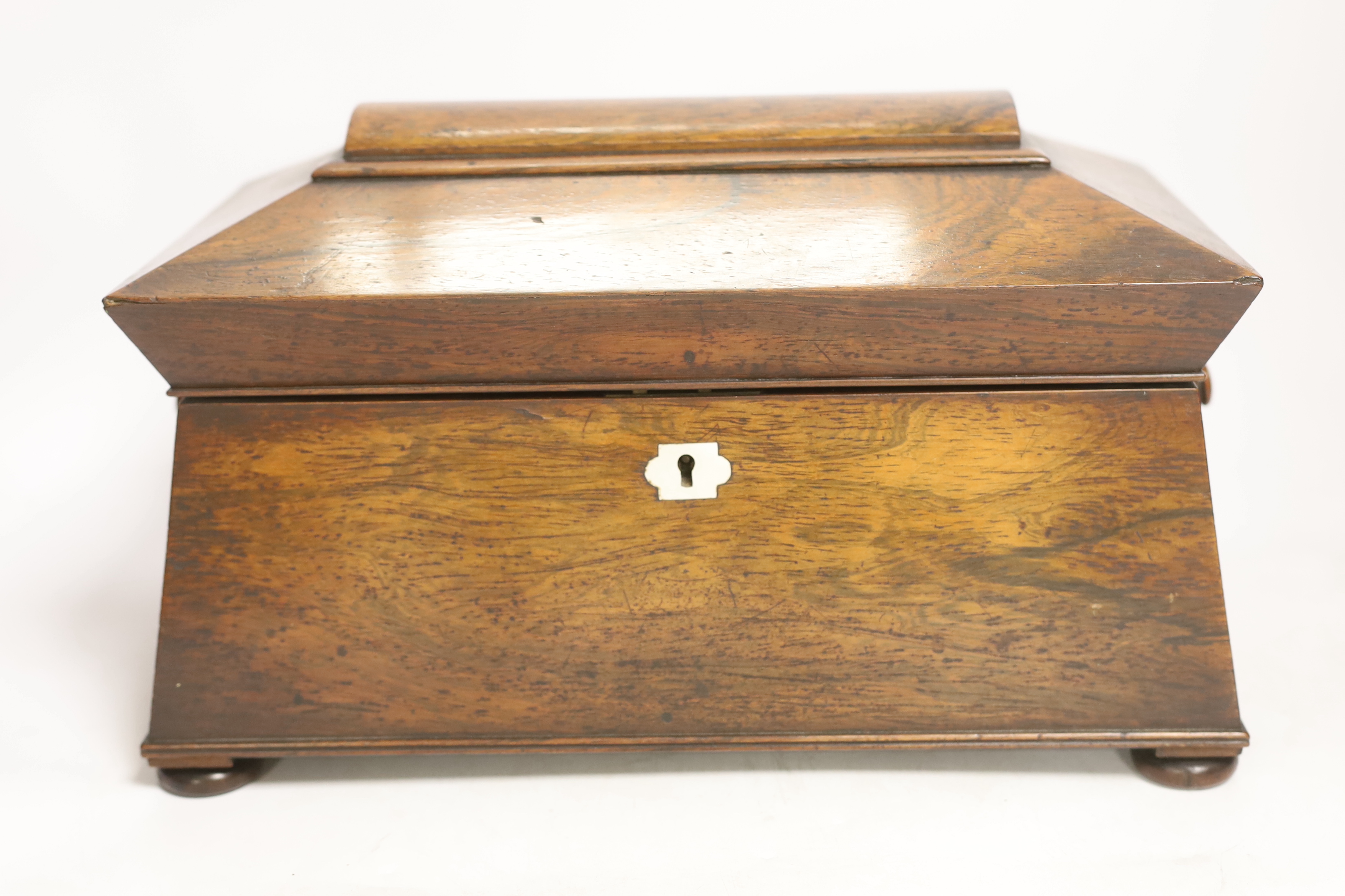 A Victorian rosewood sarcophagus shaped tea caddy with mother of pearl escutcheon, 33.5cm wide